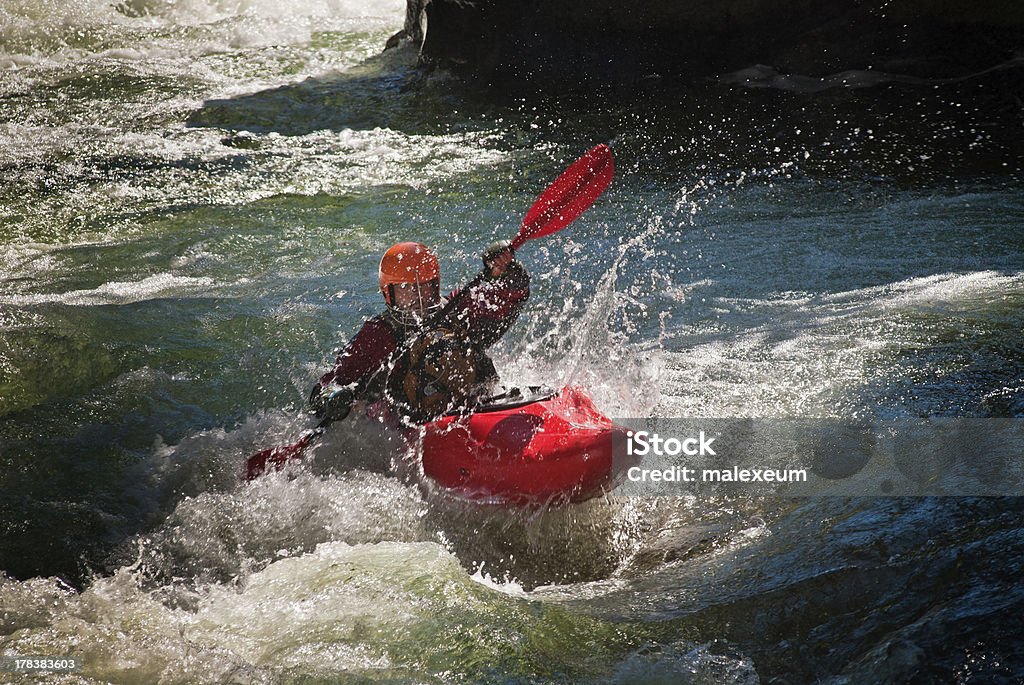 Whitewater Kayaker Running the dangerous mountain river in a kayak. White Water Kayaking Stock Photo