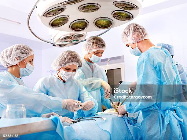 Surgeon At Work In Operating Room Stock Photo - Download Image Now - Surgery, Healthcare And Medicine, Operating Room