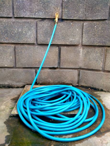 istock Faucet and blue hose reel on the floor 1783843390