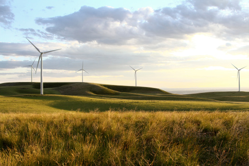 At dusk, the terraced fields and wind turbines on the mountain