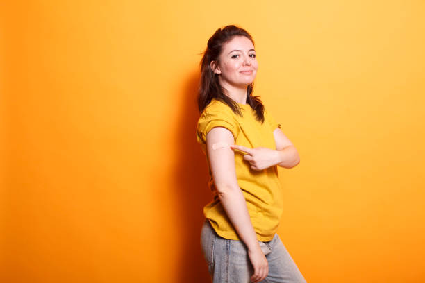 istock Woman gesturing to band aid on her arm 1783848469