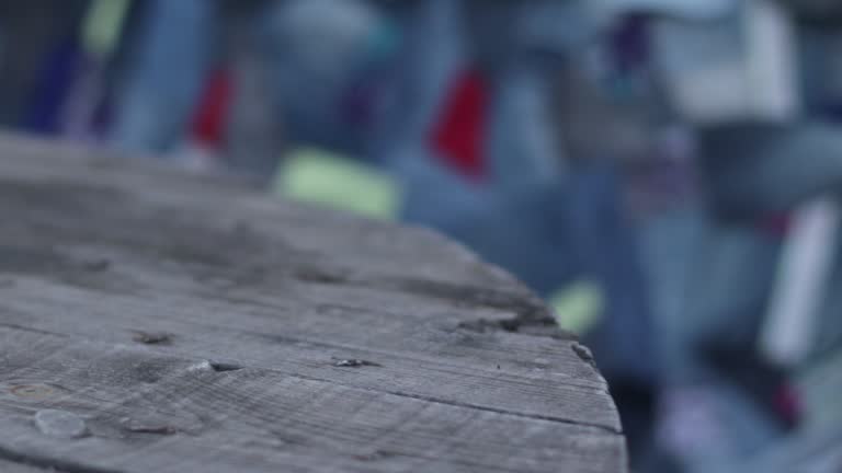 handmade plaid in patchwork style denim textiles on a wooden bench made from pallets in the garden