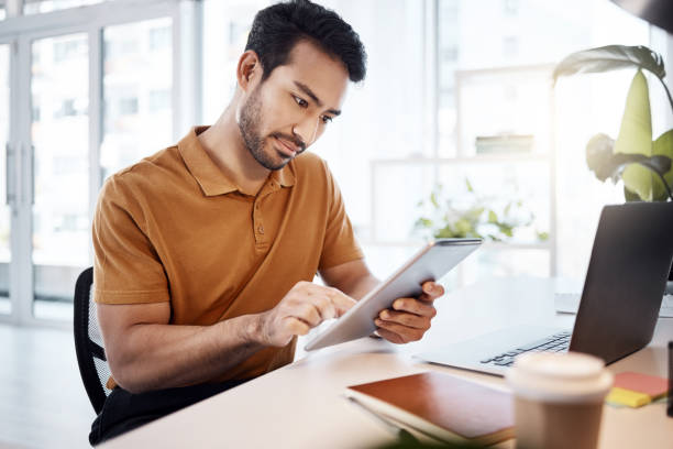 istock Tablet, office focus and man reading web research, customer experience feedback and online app analysis. Multimedia project, professional male editor and agent working on editing social media post 1783849594
