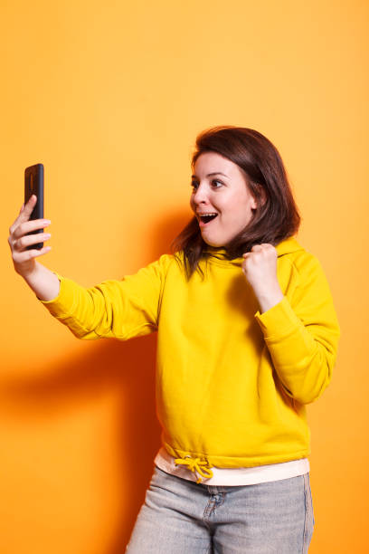 istock Woman with phone celebrating a victory 1783849615