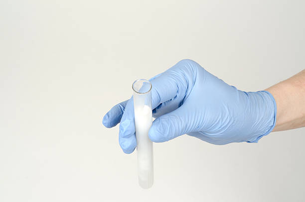 istock Hand in glove holding testing tube 178385063