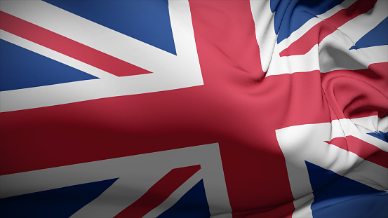 United Kingdom British english flag on flagpole textile cloth fabric waving on the top sunrise mist fog