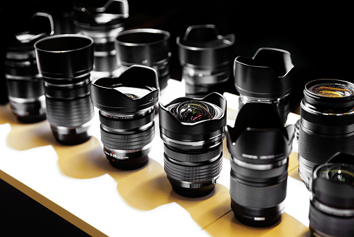 Set of different photographic lenses in a row