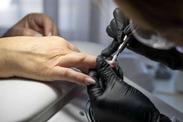istock Manicurist at work. Professional manicurist removes worn nail design 1783852123