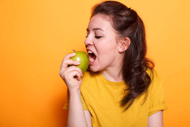 istock Healthy woman biting a green apple 1783853734