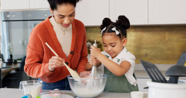 istock Baking, kitchen and mother with child with bowl learning, helping and bonding for dessert recipe. Happy family, African and mom teaching girl to bake with flour, mix ingredients and cake in home 1783865185