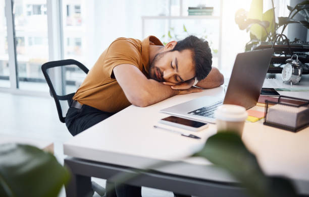 istock Tired, business man and sleeping at desk in office with burnout risk, stress problem and nap for low energy. Fatigue, lazy and depressed male employee with anxiety, overworked and bored in workplace 1783866369