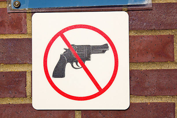 No guns sign No guns sign seen on the brick wall gun free zone sign stock pictures, royalty-free photos & images