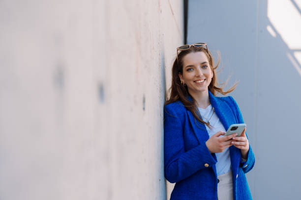 istock Woman manager looking at camera. Holding smartphone. Copyspace. Isolated 1783870386