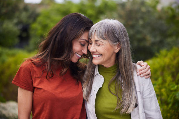 istock Woman laughing with her senior mom while walking together outside 1783870414