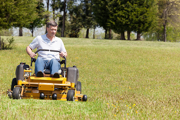 istock Senior man rides zero turn lawn mower on turf 178387239