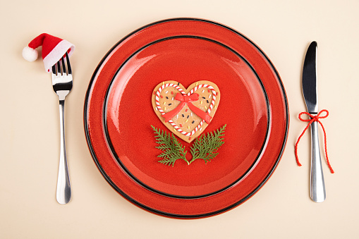 Plate served with fork and knife and Christmas decoration