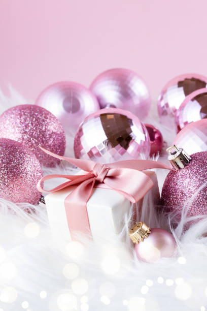 istock Pink Christmas decorations on white fur 1783876903