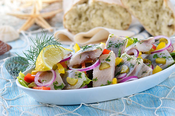 Fish salad Delicious salad of salted fillets of white herring served with ciabatta bread chopped dill stock pictures, royalty-free photos & images