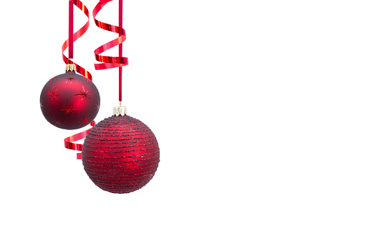 Red Christmas baubles from different angles on white background. Horizontal composition clipping path and with copy space. Front view. Great use as a design element for Christmas related concepts.