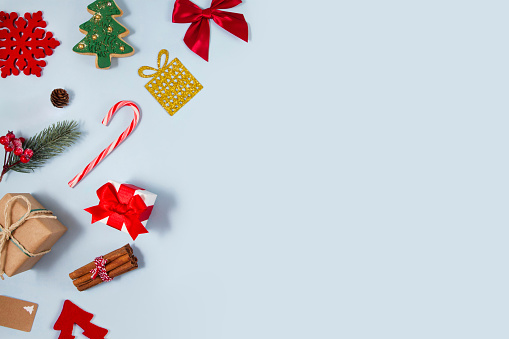 Christmas related objects and ornaments  flat lay on light blue background