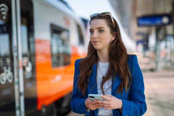istock Woman entrepreneur commuting to work. Using and holding mobile phone. Public transport concept. 1783886131