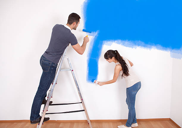 istock Couple painting wall at home 178388783