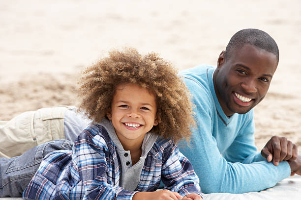 istock Father and son laying on beach 178388792