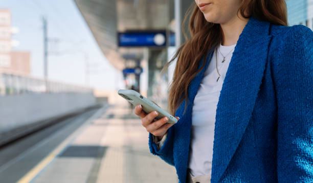 istock Midsection. Young stylish woman using mobile while waiting for train at station. Public transport. 1783890016