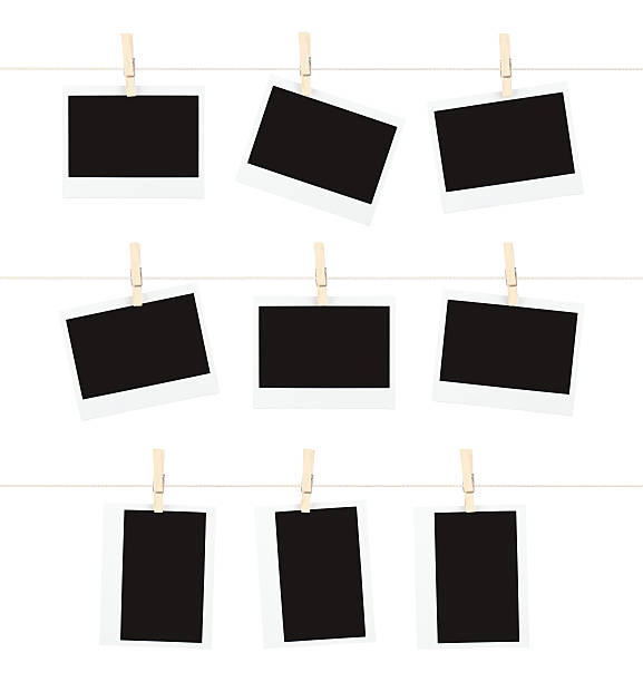 Memories on a String Three rows of three blank pieces of instant film hanging from clothespins on strings isolated on white.Other Similar Images: clothesline photos stock pictures, royalty-free photos & images
