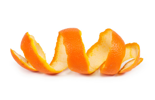 Hand holding cut in half tangerine, healthy eating citrus fruit