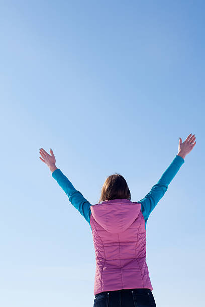 istock Teen girl staying with raised hands 178391649