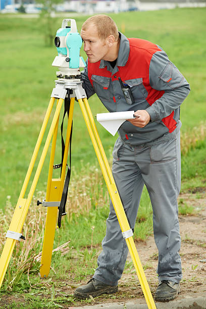 istock surveyor works with theodolite 178391702