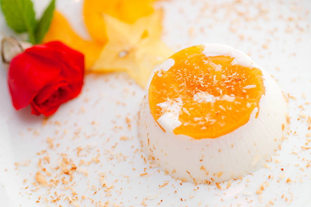 Italian dessert panna cotta with coconut and peach.