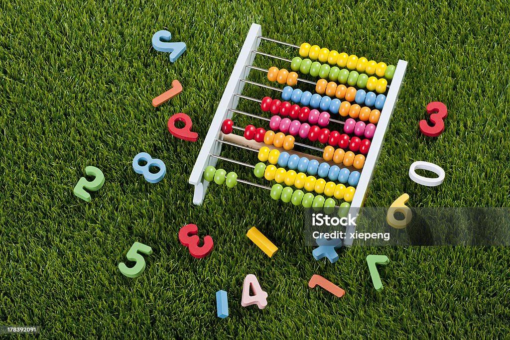 Abacus and numbers Abacus and numbers on grass Education Stock Photo