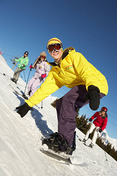 jeune famille en vacances de ski dans les montagnes - group of people teenager snow winter photos et images de collection