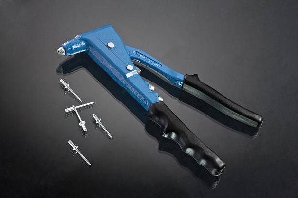 hand riveting tool hand riveting tool over glassy dark background riveting stock pictures, royalty-free photos & images