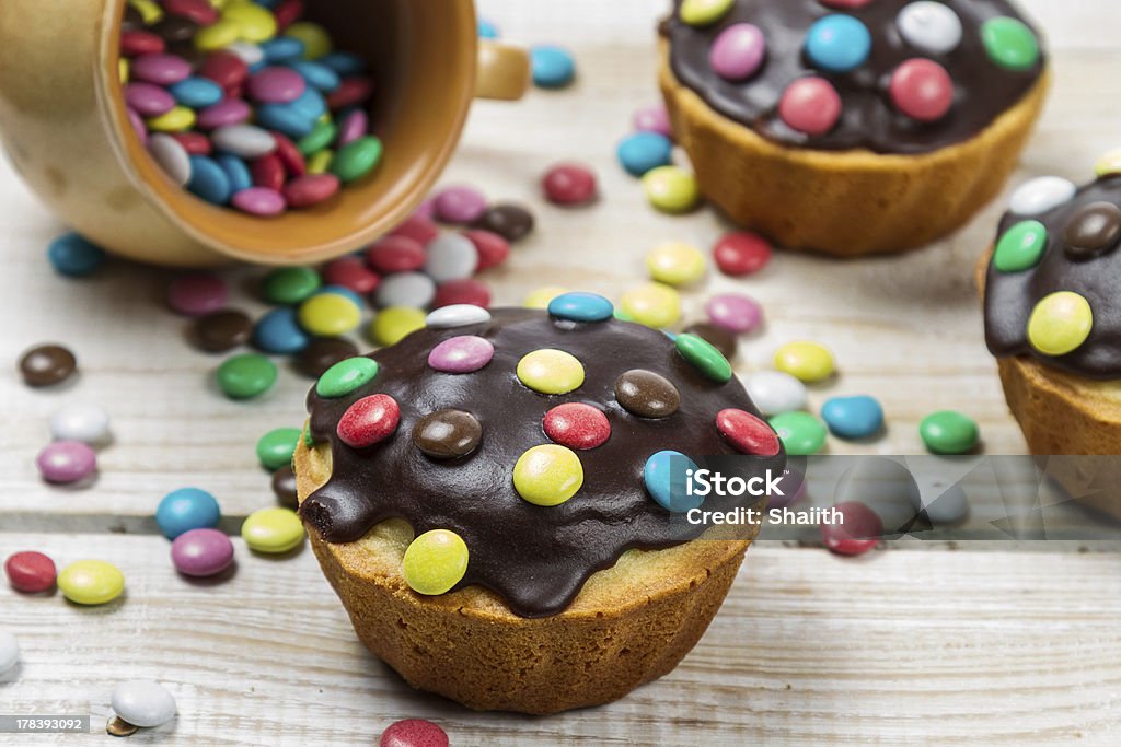 Decorating easter muffins with chocolate glaze Decorating easter muffins with chocolate glaze. Baked Stock Photo