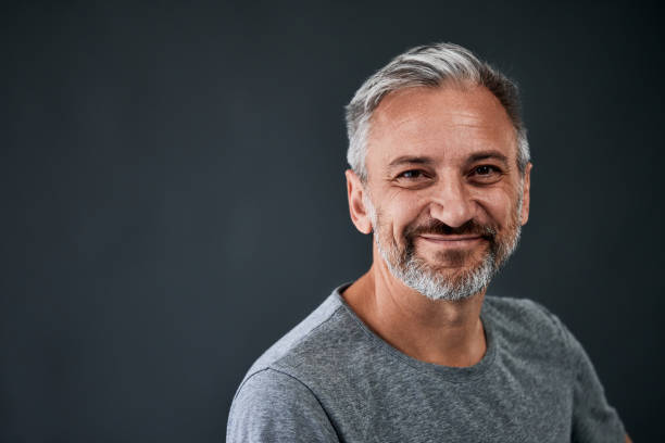 istock Portrait of a mature smiling man, posing on the grey background. 1783930962