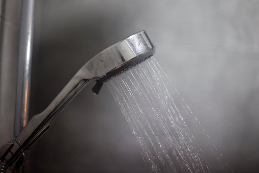 Shower head with running water.