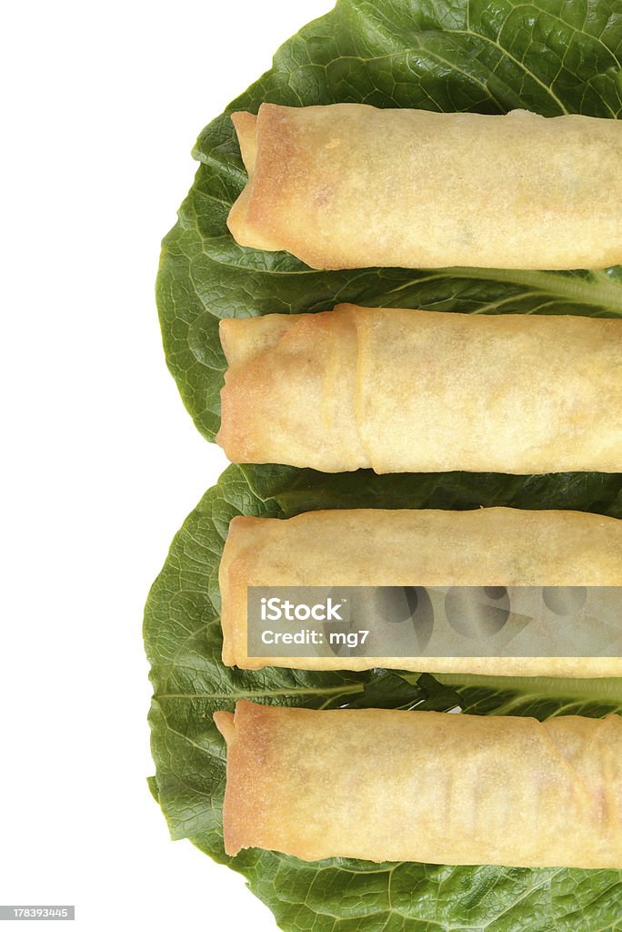 Row of spring rolls isolated top view Row of spring rolls on lettuce Spring Roll Stock Photo