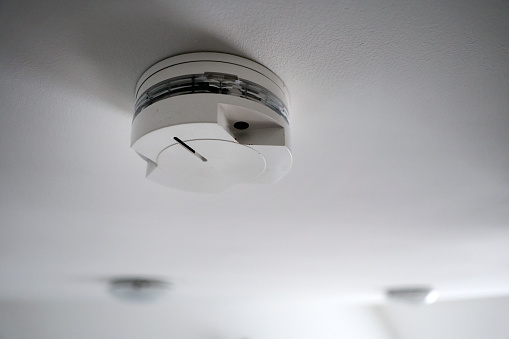 Smoke detector on a ceiling of a modern house.