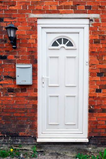 White Front Door of a Red Brick House