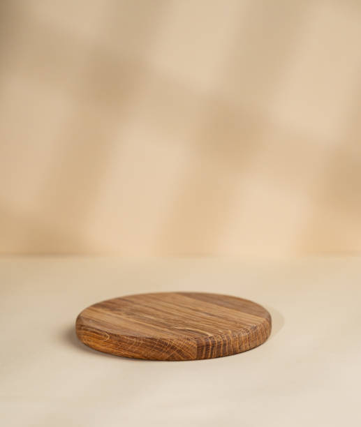 istock Abstract empty wooden round board with shadows on a yellow background. Layout concept for promotional product presentation, sale or cosmetics display. 1783946402