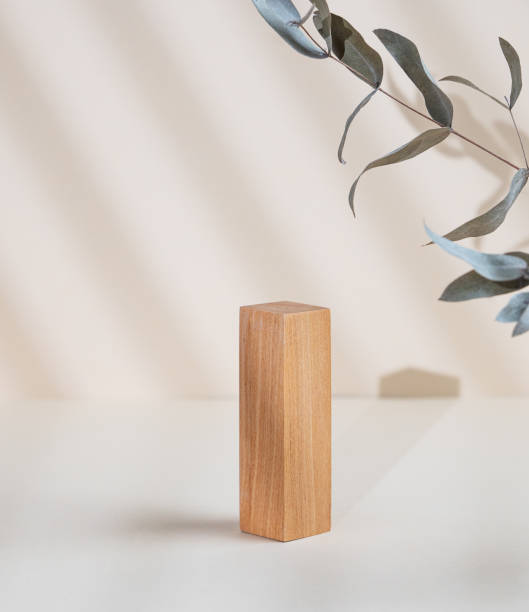 istock Abstract empty wooden podium with shadows and leaves on a beige background. Layout concept for promotional product presentation, sale or cosmetics display. 1783947521