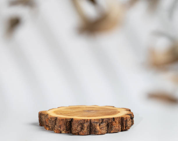 istock Abstract empty wooden podium with shadows and leaves on a gray background. Layout concept for promotional product presentation, sale or cosmetics display. 1783948111