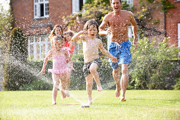 istock A happy family running through a water sprinkler 178394913