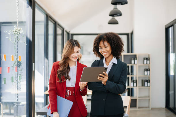 istock Two business workers talking on the smartphone and using laptop at the office. 1783955565