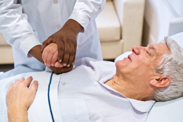 istock Doctor consoling male patient lying on bed 1783962744