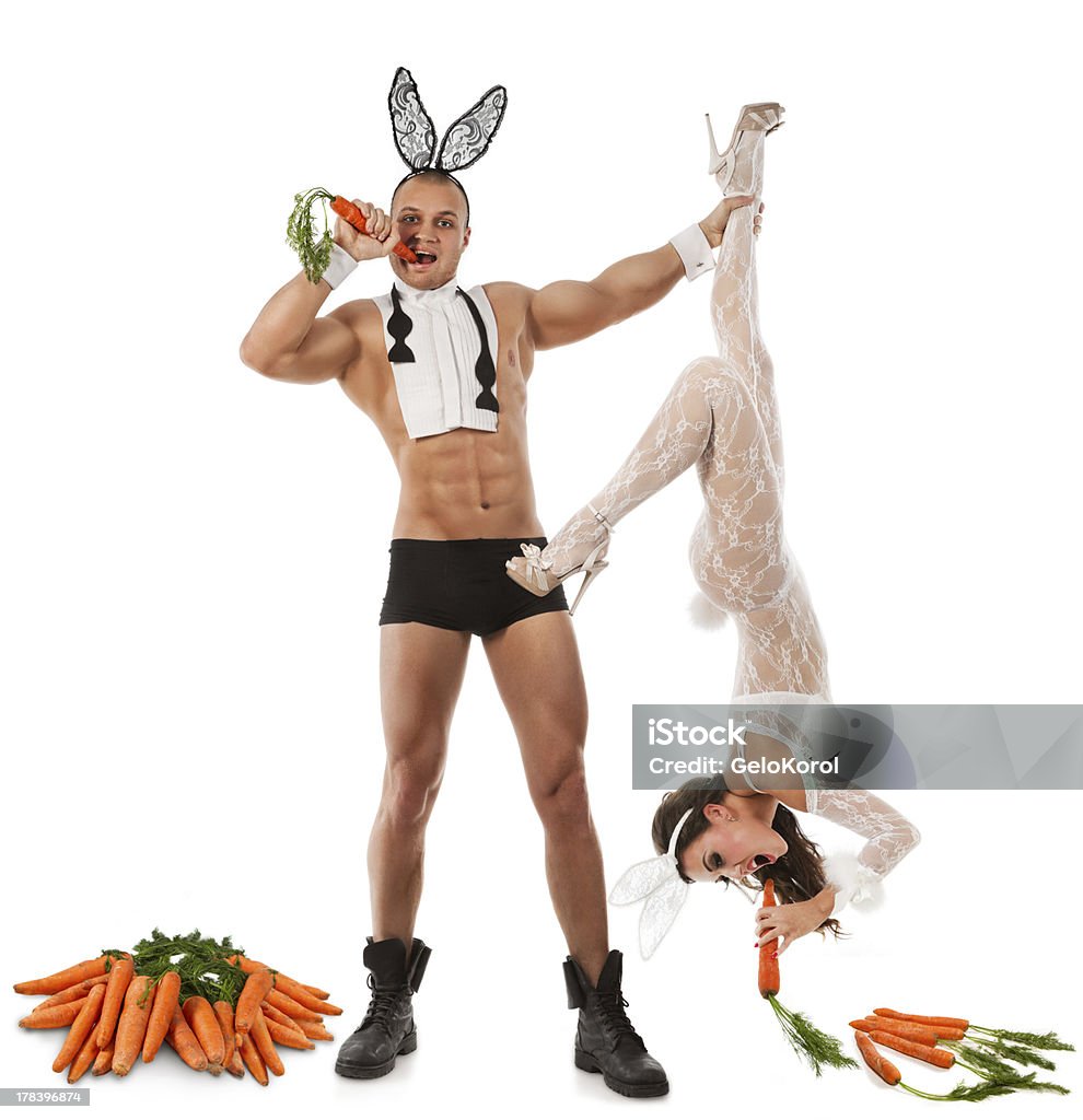 Lovely bunny couple Lovely couple in rabbit costumes with carrots Easter Stock Photo