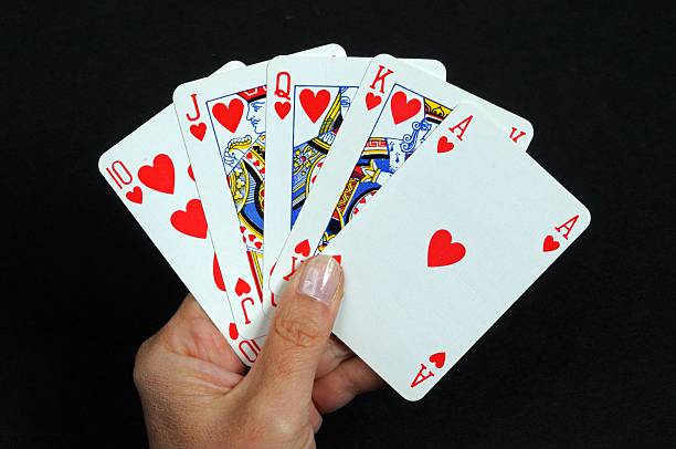 Royal flush poker hand. Royal flush poker hand in the heart suit against a black background. hand of cards stock pictures, royalty-free photos & images